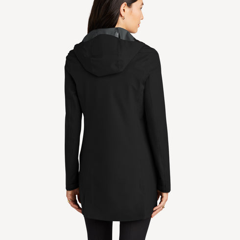 Back view of women’s black long waterproof rain shell on model – Louvóre apparel